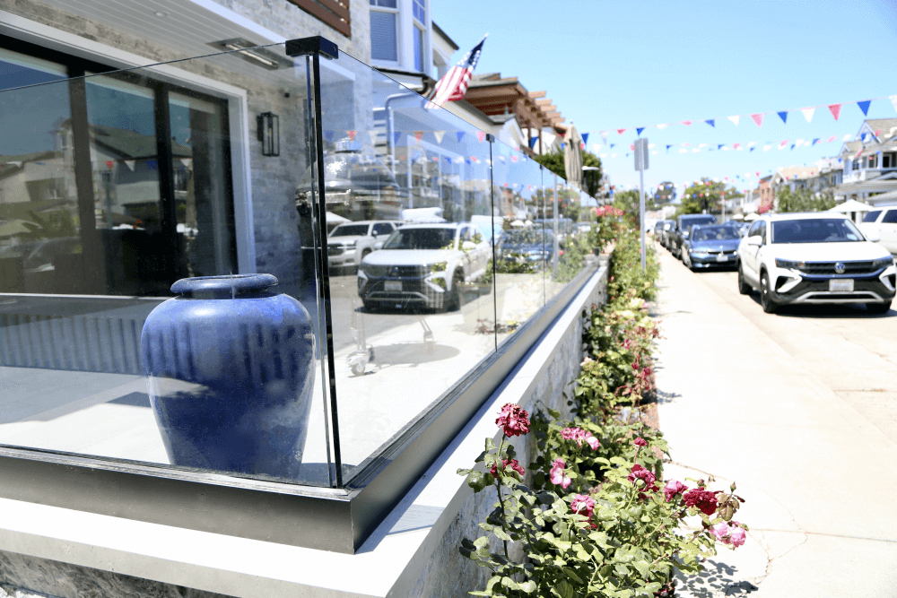Glass railing installation on beach house wind wall
